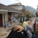 
              Residents react as they inspect houses damaged by Monday's earthquake in Cianjur, West Java, Indonesia Tuesday, Nov. 22, 2022. The earthquake has toppled buildings on Indonesia's densely populated main island, killing a number of people and injuring hundreds. (AP Photo/Rangga Firmansyah)
            