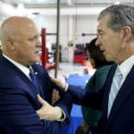 
              White House senior adviser Mitch Landrieu, left, speaks with North Carolina Gov. Roy Cooper during an event to announce rural broadband funding at Wake Tech Community College in Raleigh, N.C., on Thursday, Oct. 27, 2022. The state was among those divvying up $759 million in grants to expand high-speed internet. (AP Photo/Allen G. Breed)
            