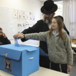 
              Ultra Orthodox Jews vote during Israel elections in Jerusalem, Tuesday, Nov. 1, 2022. (AP Photo/Oren Ziv)
            