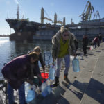 
              People collect water from a Dnipro river in Kherson, Ukraine, Tuesday, Nov. 15, 2022. Waves of Russian airstrikes rocked Ukraine on Tuesday, with authorities immediately announcing emergency blackouts after attacks from east to west on energy and other facilities knocked out power and, in the capital, struck residential buildings. (AP Photo/Efrem Lukatsky)
            