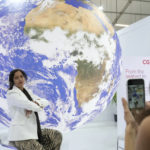 
              A woman poses for photos at the COP27 U.N. Climate Summit, Monday, Nov. 7, 2022, in Sharm el-Sheikh, Egypt. (AP Photo/Peter Dejong)
            