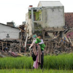 
              A man carries belongings salvaged from the ruins of his earthquake-damaged house in Cianjur, West Java, Indonesia Tuesday, Nov. 22, 2022. The earthquake has toppled buildings on Indonesia's densely populated main island, killing a number of people and injuring hundreds. (AP Photo/Tatan Syuflana)
            