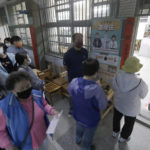 
              Local residents line up to cast their ballots at a polling station in New Taipei City, Taiwan, Saturday, Nov. 26, 2022. Voters headed to the polls across Taiwan in a closely watched local election Saturday that will determine the strength of the island's major political parties ahead of the 2024 presidential election. (AP Photo/Chiang Ying-ying)
            