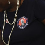 
              A President Joe Biden supporter talks with other supporters before President Joe Biden arrives to speak Saturday, Nov. 5, 2022, at Jones Elementary School in Joliet, Ill. (AP Photo/Paul Beaty)
            