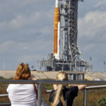 
              Visitors at Kennedy Space Center view NASA's new moon rocket as she sits on Launch Pad 39-B Monday, Nov. 14, 2022, in Cape Canaveral, Fla. NASA's 21st-century moon-exploration program, named Artemis after Apollo's mythological twin sister. NASA is targeting an early Wednesday morning launch attempt. (AP Photo/Terry Renna)
            