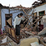 
              A woman reacts as she inspects her house that was badly damaged during an earthquake in Cianjur, West Java, Indonesia Tuesday, Nov. 22, 2022. The earthquake has toppled buildings on Indonesia's densely populated main island, killing a number of people and injuring hundreds. (AP Photo/Tatan Syuflana)
            