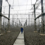 
              FILE - A technician walks under power lines at a power plant in Jakarta, Indonesia, Tuesday, Oct. 5, 2010. Indonesia signed deals with international lenders and major nations on Tuesday, Nov. 15, 2022, on the sidelines of the G20 under which it will receive billions of dollars in funding to help the country increase its use of renewable energy and reduce its reliance on coal. (AP Photo/Irwin Fedriansyah, File)
            