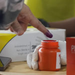 
              A man dips the tip of his finger in a bottle of ink to mark that he has given his vote, during the election at a polling station in Seberang Perai, Penang state, Malaysia, Saturday, Nov. 19, 2022. Malaysians began casting ballots Saturday in a tightly contested national election that will determine whether the country's longest-ruling coalition can make a comeback after its electoral defeat four years ago. (AP Photo/Vincent Thian)
            