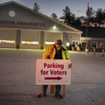 
              Roy McPhail sets up a sign shortly before the doors opened to voters at 6:00 A.M. at the fire station, Tuesday, Nov. 8, 2022, in New Gloucester, Maine. (AP Photo/Robert F. Bukaty)
            