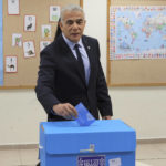 
              Israeli Prime Minister Yair Lapid casts his vote in the country's fifth election in four years, at a polling station in Tel Aviv Tuesday, Nov. 1, 2022. For the fifth time since 2019, Israelis were voting in national elections on Tuesday, hoping to break the political deadlock that has paralyzed the country for the past three and a half years. (Jack Guez/Pool Photo via AP)
            