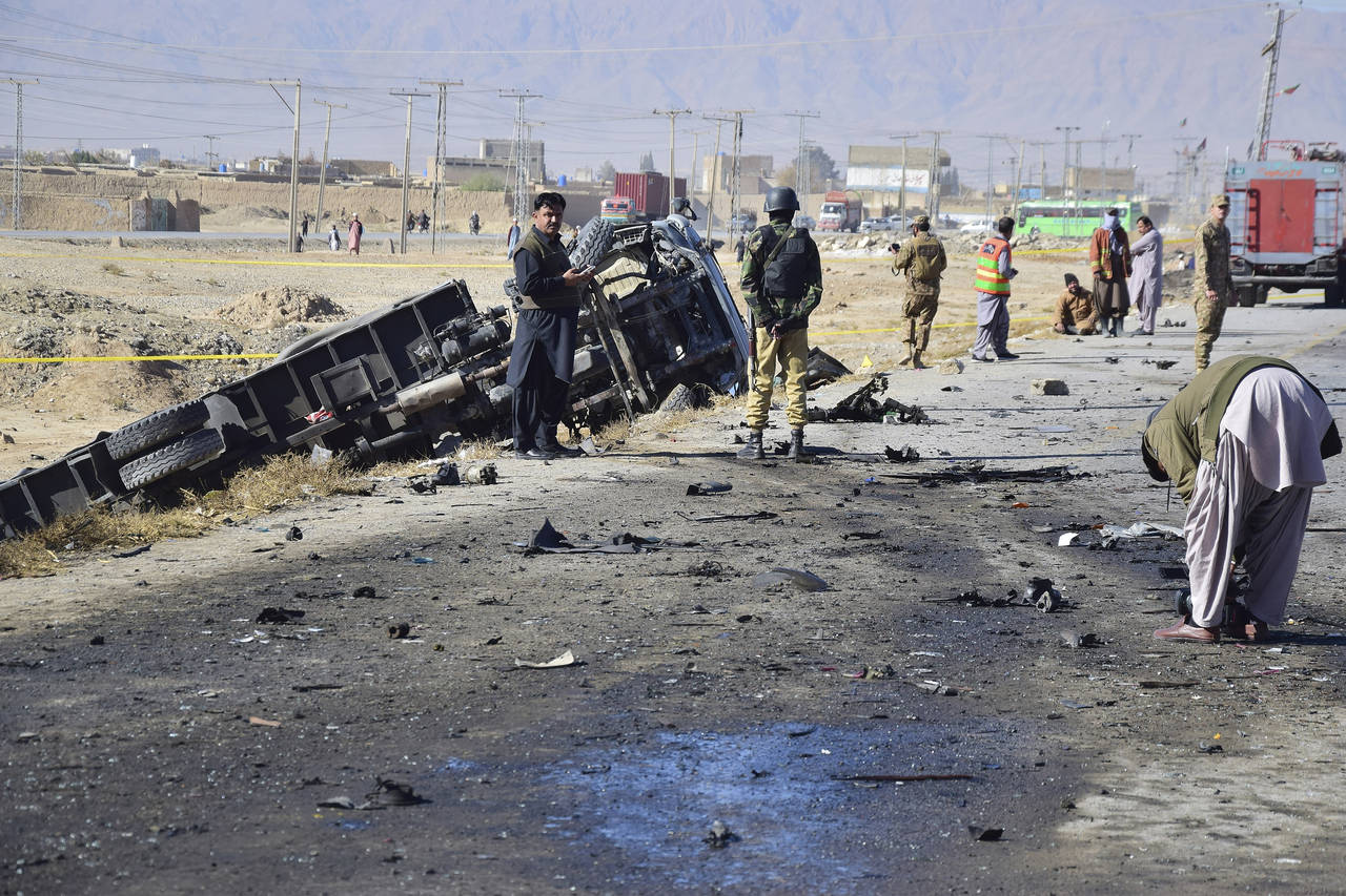 Investigators collect evidence at the site of a suicide bombing on the outskirt of Quetta, Pakistan...