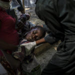 
              A youth suffering from cholera is helped upon arrival at a clinic run by Doctors Without Borders in Port-au-Prince, Haiti, on Oct. 27, 2022. (AP Photo/Ramon Espinosa)
            