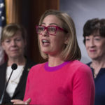 
              Sen. Kyrsten Sinema, D-Ariz., flanked by Sen. Tammy Baldwin, D-Wis., left, and Sen. Susan Collins, R-Maine, speaks to reporters following Senate passage of the Respect for Marriage Act, at the Capitol in Washington, Tuesday, Nov. 29, 2022. (AP Photo/J. Scott Applewhite)
            