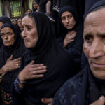 
              Kashmiri Shiite Muslim women mourn as they participate in a Muharram procession on Dal lake, near Srinagar, Indian controlled Kashmir, on Aug. 8, 2022. Muharram is a month of mourning in remembrance of the martyrdom of Imam Hussein, the grandson of Prophet Mohammed. (AP Photo/ Dar Yasin)
            