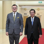 
              In this photo provided by Cambodia's Government Cabinet, Cambodian Prime Minister Hun Sen, right, and Ukrainian Foreign Minister Dmytro Kuleba, left, pose for a photo, during a welcome meeting at Peace Palace in Phnom Penh, Cambodia, Wednesday, Nov. 9, 2022. (Kok Ky/Cambodia's Government Cabinet via AP)
            