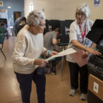
              Sally Klopfer, left, is helped by election volunteer Mona Lookhard to introduce her ballot in the counting machine at a polling center in the South Valley area of Albuquerque, N.M., Tuesday, Nov. 8, 2022 (AP Photo/Andres Leighton)
            