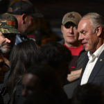 
              Former Interior Secretary Ryan Zinke, Republican candidate in Montana's 1st Congressional District, talks with people at an election-night watch party in Whitefish, Mont., Tuesday, Nov. 8, 2022. (AP Photo/Tommy Martino)
            