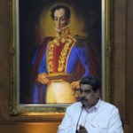 
              Venezuelan President Nicolas Maduro, backdropped by a portrait of independence hero Simon Bolivar, attends a signing ceremony with his Colombian counterpart, in the Miraflores Presidential Palace, in Caracas, Venezuela, Tuesday, Nov. 1, 2022. (AP Photo/Ariana Cubillos)
            