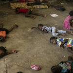 
              Children sleep on the floor of a school turned into a shelter after they were forced to leave their homes in Cite Soleil due to clashes between armed gangs, in Port-au-Prince, Haiti, on July 23, 2022. (AP Photo/Odelyn Joseph)
            