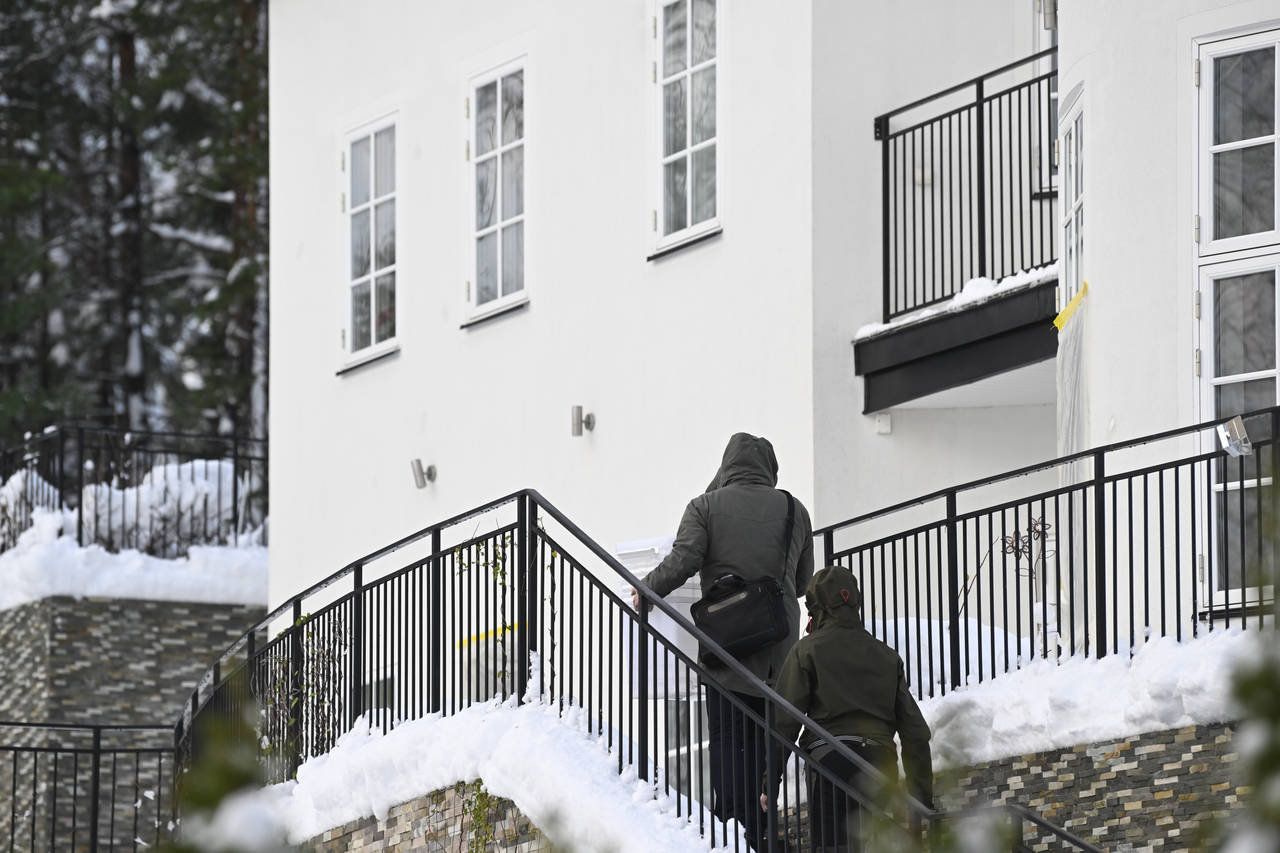 Two unidentified people are seen approaching a house where the Swedish Security Service allegedly a...