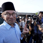 
              FILE - Opposition leader Anwar Ibrahim shows his inked finger to the media after voting at a polling station in Seberang Perai, Penang state, Malaysia on Nov. 19, 2022. Malaysia's king on Thursday, Nov. 24, 2022, named Anwar as the country's prime minister, ending days of uncertainties after divisive general elections produced a hung Parliament. (AP Photo/Vincent Thian, File)
            