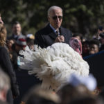 
              President Joe Biden pardons Chocolate, the national Thanksgiving turkey, at the White House in Washington, Monday, Nov. 21, 2022. On stage with the president are Ronald Parker, Chairman of the National Turkey Federation, and Alexa Starnes, daughter of the owner of Circle S Ranch. (AP Photo/Carolyn Kaster)
            