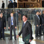 
              FILE - Brazilian President Jair Bolsonaro arrives to speak from his official residence of Alvorada Palace in Brasilia, Brazil, Nov. 1, 2022, the leader's first public comments since losing the Oct. 30 presidential runoff. Bolsonaro has dropped out of public view and has not disavowed the recent emergence of violence by his supporters who refuse to accept his narrow defeat. (AP Photo/Eraldo Peres, File)
            