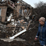 
              A woman walks past her house that was damaged in Russian shelling in Kramatorsk, Ukraine, Saturday, Nov. 19, 2022. (AP Photo/Andriy Andriyenko)
            