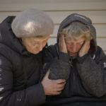 
              A neighbor comforts Natalia Vlasenko, whose husband, Pavlo Vlasenko, and grandson, Dmytro Chaplyhin, called Dima, were killed by Russian forces, as she cries in her garden in Bucha, Ukraine, Monday, April 4, 2022. Russian soldiers picked up Dima during a Mar. 4 sweep, accused him of being a spotter helping the Ukrainian military and brought him to their headquarters at 144 Yablunska Street. Ukrainian prosecutors now say those responsible for the violence at 144 Yablunska were soldiers from the 76th Guards Airborne Assault Division, under the ultimate battlefield command of Alexander Chaiko, a colonel general known for his brutality as leader of Russia's troops in Syria. (AP Photo/Vadim Ghirda)
            