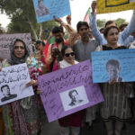 
              Supporters of former Pakistani Prime Minister Imran Khan's party, Pakistan Tehreek-e-Insaf hold a demonstration to condemn a shooting incident on their leader's convoy, in Lahore, Pakistan, Friday, Nov. 4, 2022. Khan who narrowly escaped an assassination attempt on his life the previous day when a gunman fired multiple shots and wounded him in the leg during a protest rally is listed in stable condition after undergoing surgery at a hospital, a senior leader from his party said Friday. (AP Photo/K.M. Chaudhry)
            