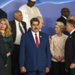 
              The President of Venezuela, Nicolás Maduro Moros, center, stands next to the President of the European Commission Ursula von der Leyen, center center right, as leaders prepare themselves for a group photo at the COP27 U.N. Climate Summit, in Sharm el-Sheikh, Egypt, Monday, Nov. 7, 2022. (AP Photo/Nariman El-Mofty)
            