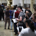
              Voters wait in line to make a corrections to their ballots for the midterm elections at City Hall in Philadelphia, Monday, Nov. 7, 2022. (AP Photo/Matt Rourke)
            