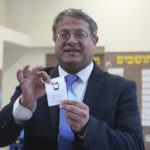 
              Israeli far-right lawmaker Itamar Ben Gvir shows his ballot in the West Bank settlement of Kiryat Arba during Israeli elections, Tuesday, Nov. 1, 2022. (AP Photo/Tsafrir Abayov)
            