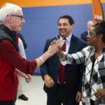 
              Wisconsin Democratic Gov. Tony Evers shakes hands with Rep. Gwen Moore, D-Wis., at a campaign stop Thursday, Oct. 27, 2022, in Milwaukee. (AP Photo/Morry Gash)
            
