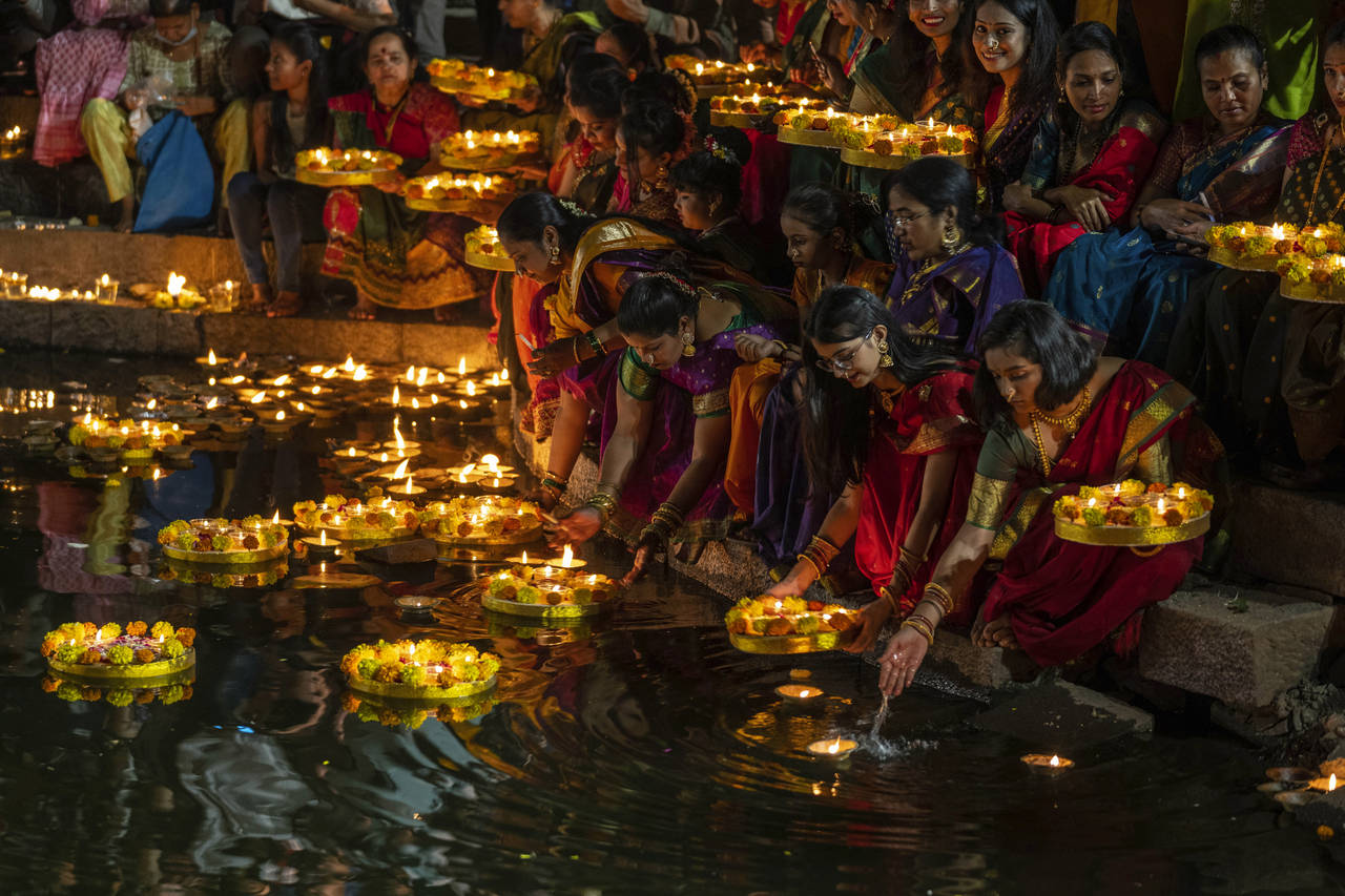 Hindu women light oil lamps at the Banganga pond as they celebrate Dev Diwali festival in Mumbai, I...