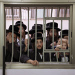 
              Ultra-Orthodox Jews watch their Rabbi votes during Israel elections in Bnei Brak, Tuesday, Nov. 1, 2022. Israel is holding its fifth election in less than four years. (AP Photo/Oded Balilty)
            