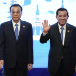 
              Cambodia Prime Minister Hun Sen waves as China's Premier Li Keqiang stand next to him during group photo of the ASEAN - China Summits (Association of Southeast Asian Nations) in Phnom Penh, Cambodia, Friday, Nov. 11, 2022. Association of Southeast Asian Nations leaders struggled Friday to come to a consensus on how to pressure Myanmar to comply with a plan for peace, with violence in the member state spiraling out of control since the military seized power in 2021. (AP Photo/Heng Sinith)
            