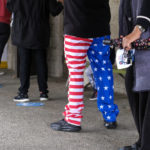 
              Jerry Guerra, 50, wearing pants designed as the U.S. flag waits in line at a voting station, Tuesday, Nov. 8, 2022, in Los Angeles. (AP Photo/Ringo H.W. Chiu)
            