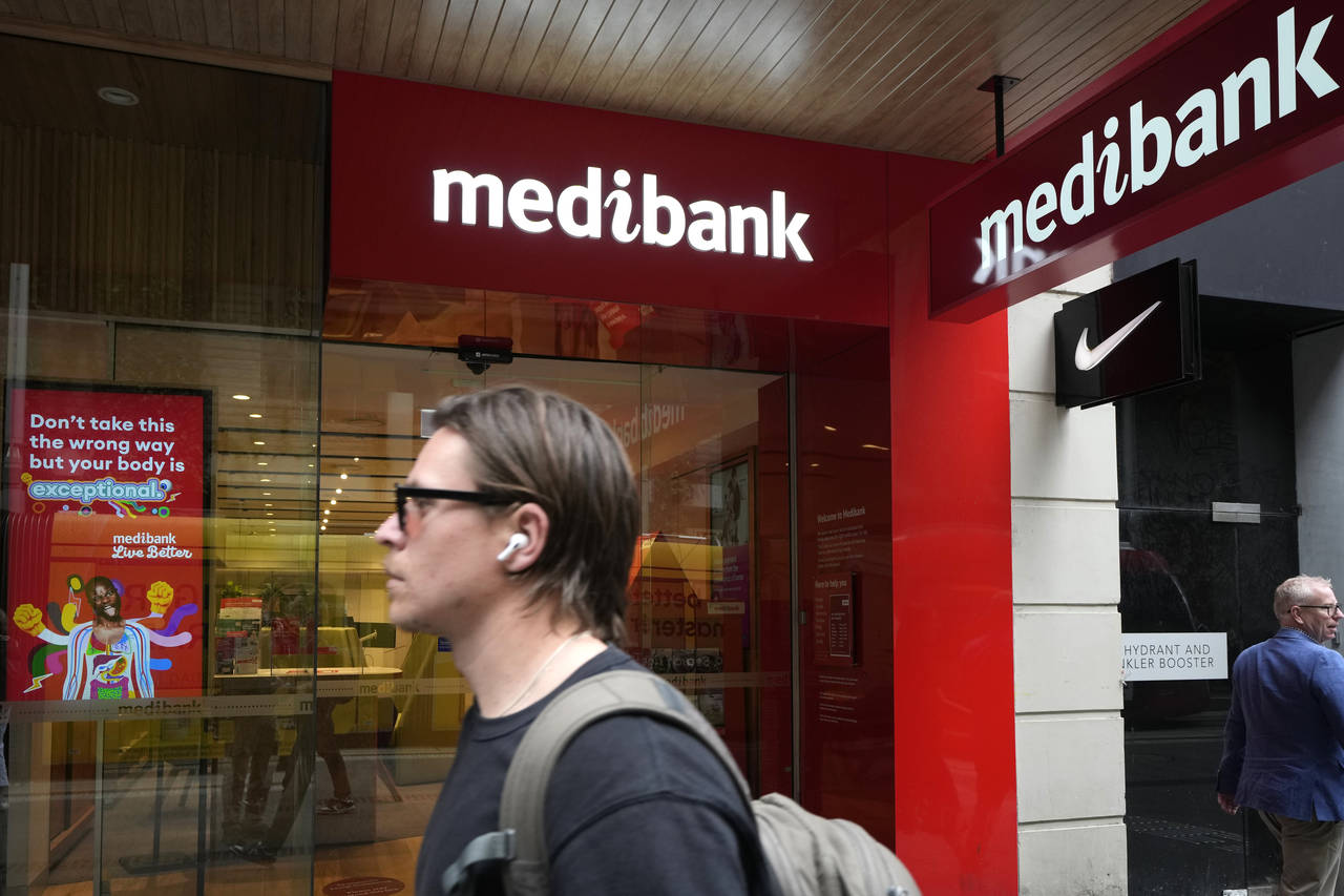FILE - A man walks past a Medibank branch in Sydney on Oct. 26, 2022. Extortionists have dumped sto...