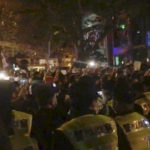 
              In this image from video obtained by The Associated Press, police, foreground, watch protesters in Shanghai on Saturday, Nov. 26, 2022. Protests against China’s restrictive COVID measures appeared in a number of cities Saturday night, in displays of public defiance fanned by anger over a deadly fire in the western Xinjiang region. (AP Photo)
            