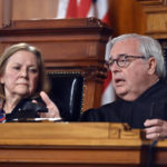 
              Kentucky Supreme Court Chief Justice John D. Minton Jr., right, asks a question to the Kentucky Solicitor General as Justice Lisabeth Hughes listens during arguments before the court whether to temporarily pause the state's abortion ban in Frankfort, Ky., Tuesday, Nov. 15, 2022. (AP Photo/Timothy D. Easley)
            