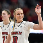 
              FILE - Louisville guard Hailey Van Lith (10) waves to the crowd at the end of a women's NCAA tournament college basketball second-round game against Gonzaga in Louisville, Ky., Sunday, March 20, 2022. Some star women’s players have already decided to stay in school rather than make their earliest possible jump to the WNBA and more are on the way with NIL deals and chartered travel offering appeal compared to rookie salaries and commercial flights in the WNBA. (AP Photo/Timothy D. Easley, File)
            