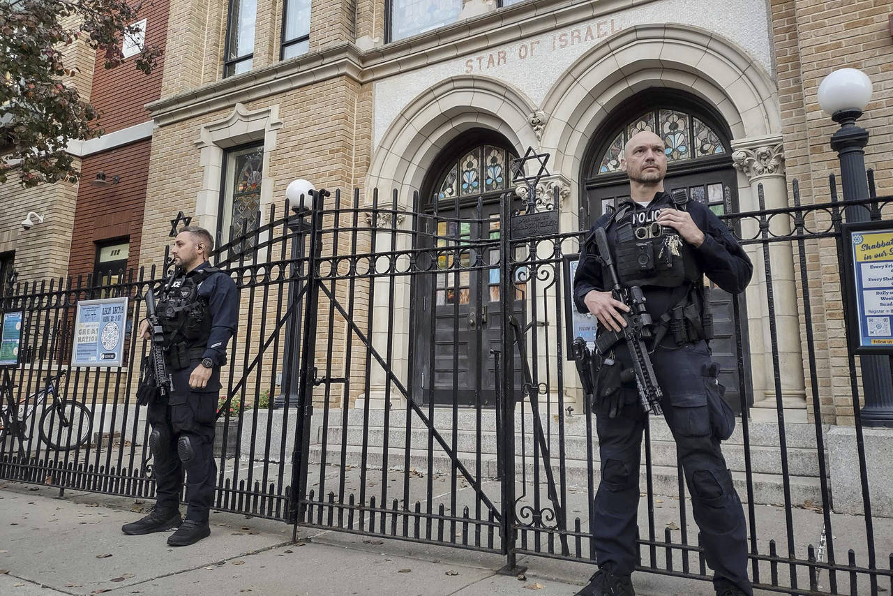 Hoboken Police officers stand watch outside the United Synagogue of Hoboken, Thursday, Nov. 3, 2022...