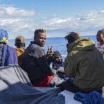 
              Migrants on the deck of the Rise Above rescue ship run by the German organization Mission Lifeline, in the Mediterranean Sea off the coasts of Sicily, southern Italy, Sunday, Nov. 6, 2022. Italy allowed one rescue ship, the German run Humanity 1, to enter the Sicilian port and begin disembarking minors, but refused to respond to requests for safe harbor from three other ships carrying 900 more people in nearby waters. (Severine Kpoti/Mission Lifeline Via AP)
            