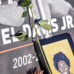 
              A flower lies next to a picture of Lavel Davis Jr. during a memorial service on Saturday, Nov. 19, 2022, at John Paul Jones Arena on the campus of the University of Virginia in Charlottesville, Va. On Sunday, Nov. 13, University of Virginia football players from Devin Chandler, Lavel Davis Jr. and D'Sean Perry were shot and killed by a teammate following a school field trip to Washington. (Shaban Athuman/Richmond Times-Dispatch via AP)
            