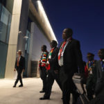 
              President Emmerson Mnangagwa, of Zimbabwe, center, walks to the plenary session of the COP27 U.N. Climate summit in Sharm el-Sheikh, Egypt, Monday, Nov. 7, 2022. (AP Photo/Peter Dejong)
            