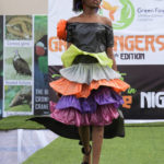 Rose Musa, wearing an outfit made from recycled plastic bags, walk on the runway during a 'trashion show' in Sangotedo Lagos, Nigeria, Saturday, Nov. 19, 2022. (AP Photo/Sunday Alamba)