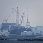 
              FILE - The Fukushima Daiichi nuclear power plant sits in coastal towns of both Okuma and Futaba, as seen from the Ukedo fishing port in Namie town, northeastern Japan, Wednesday, March 2, 2022. Repayment of the more than 10 trillion yen ($68 billion) government funding for cleanup and compensation for the Fukushima Daiichi nuclear plant disaster has been delayed the Board of Audit said in a report released Monday, Nov. 7, 2022. (AP Photo/Hiro Komae, File)
            