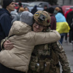
              A woman hugs Ukrainian officer as they celebrate the recapturing Kherson, Ukraine, Saturday, Nov. 12, 2022. People across Ukraine awoke from a night of jubilant celebrating after the Kremlin announced its troops had withdrawn to the other side of the Dnieper River from Kherson. The Ukrainian military said it was overseeing "stabilization measures" around the city to make sure it was safe. (AP Photo/Yevhenii Zavhorodnii)
            