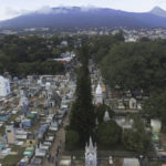 
              General view of the Nueva San Salvador Cemetery, with the San Salvador volcano in the background, during the Day of the Dead celebrations in Santa Tecla, El Salvador, Wednesday, Nov. 2, 2022. Santa Tecla Mayor Henry Flores said the crews had destroyed nearly 80 tombstones in the municipal cemetery and erased gang-related graffiti. (AP Photo/Salvador Melendez)
            